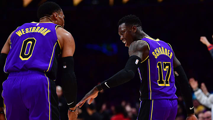 Dec 16, 2022; Los Angeles, California, USA; Los Angeles Lakers guard Dennis Schroder (17) celebrates his three point basket scored against the Denver Nuggets with guard Russell Westbrook (0) during the second half at Crypto.com Arena. Mandatory Credit: Gary A. Vasquez-Imagn Images