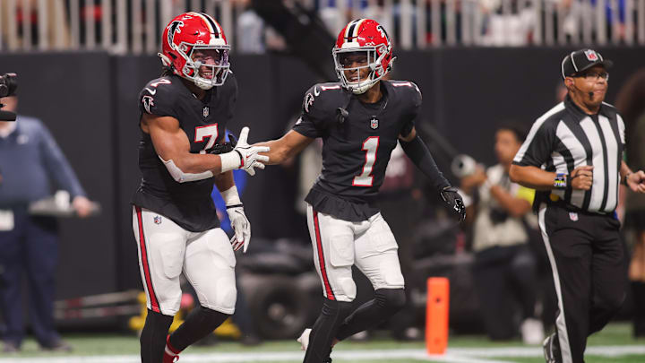 Dec 29, 2025; Atlanta, Georgia, USA; Atlanta Falcons running back Bijan Robinson (7) celebrates after a touchdown with wide receiver Darnell Mooney (1) against the Los Angeles Rams in the first quarter at Mercedes-Benz Stadium. Mandatory Credit: Brett Davis-Imagn Images
