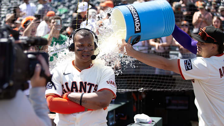 Jun 21, 2025; San Francisco, California, USA; San Francisco Giants shortstop Willy Adames (right) douses teammate Rafael Devers following their  victory over the Boston Red Sox at Oracle Park. Mandatory Credit: D. Ross Cameron-Imagn Images