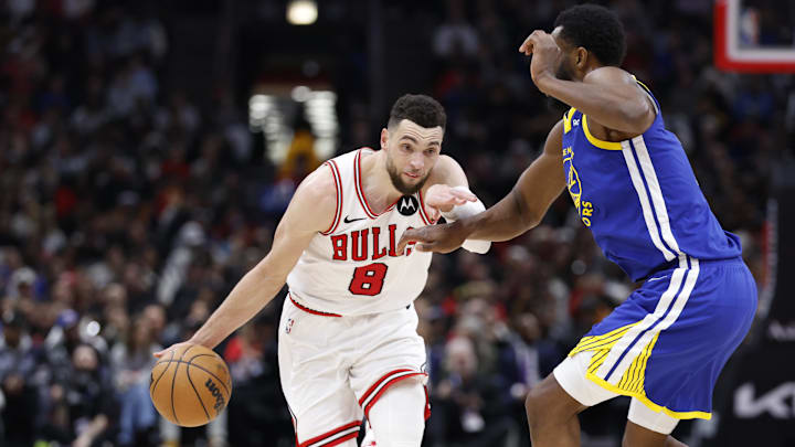 Jan 12, 2024; Chicago, Illinois, USA; Chicago Bulls guard Zach LaVine (8) drives against Golden State Warriors forward Andrew Wiggins (22) during the second half at United Center. Mandatory Credit: Kamil Krzaczynski-Imagn Images