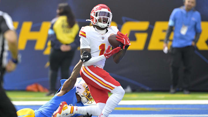 Sep 29, 2024; Inglewood, California, USA;  Kansas City Chiefs wide receiver Xavier Worthy (1) is defended by Los Angeles Chargers cornerback Kristian Fulton (7) as he hangs on to a touchdown pass in the first half at SoFi Stadium. Mandatory Credit: Jayne Kamin-Oncea-Imagn Images