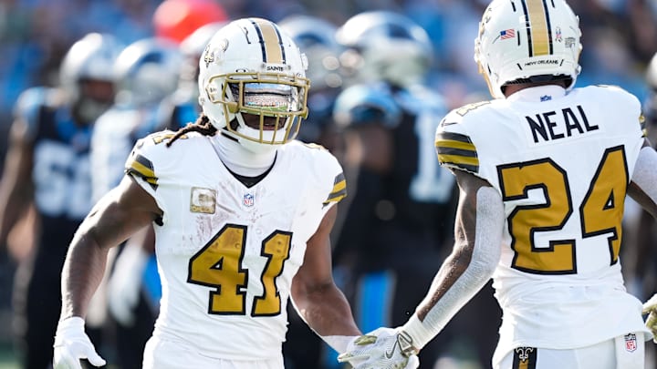 Nov 9, 2025; Charlotte, North Carolina, USA; New Orleans Saints running back Alvin Kamara (41) high fives New Orleans Saints running back Devin Neal (24) during the second quarter against the Carolina Panthers at Bank of America Stadium. 