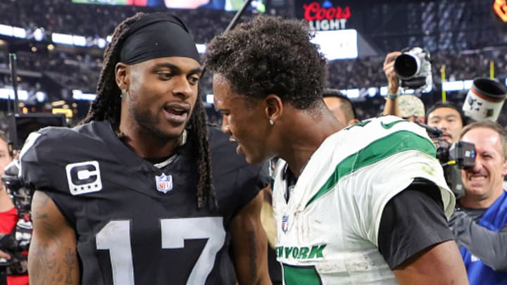 Former Las Vegas Raiders wide receiver Davante Adams and New York Jets wide receiver Garrett Wilson talk on the field after a November 2023 game at Allegiant Stadium. 