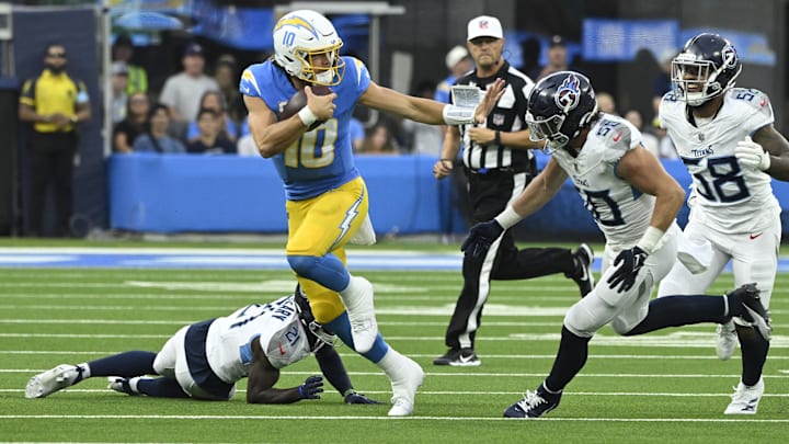 Los Angeles Chargers quarterback Justin Herbert runs with the ball against the Tennessee Titans. Los Angeles Chargers quarterback Justin Herbert runs with the ball against the Tennessee Titans.
