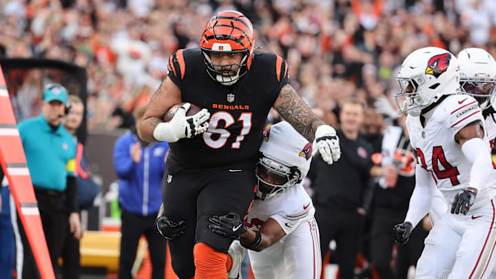 Dec 28, 2025; Cincinnati, Ohio, USA; Cincinnati Bengals guard Cody Ford (61) runs against Arizona Cardinals cornerback Darren Hall (30) and safety Jalen Thompson (34) during the second half at Paycor Stadium. Mandatory Credit: Joseph Maiorana-Imagn Images Dec 28, 2025; Cincinnati, Ohio, USA; Cincinnati Bengals guard Cody Ford (61) runs against Arizona Cardinals cornerback Darren Hall (30) and safety Jalen Thompson (34) during the second half at Paycor Stadium. Mandatory Credit: Joseph Maiorana-Imagn Images