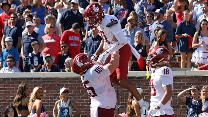 Oct 11, 2025; Oxford, Mississippi, USA; Washington State Cougars offensive lineman Brock Dieu (65) lifts wide receiver Tony Freeman (0) after a touchdown during the fourth quarter om at Vaught-Hemingway Stadium. Mandatory Credit: Petre Thomas-Imagn Images Oct 11, 2025; Oxford, Mississippi, USA; Washington State Cougars offensive lineman Brock Dieu (65) lifts wide receiver Tony Freeman (0) after a touchdown during the fourth quarter om at Vaught-Hemingway Stadium. Mandatory Credit: Petre Thomas-Imagn Images