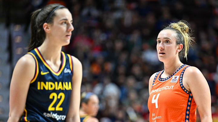 Connecticut Sun guard Marina Mabrey stares at Indiana Fever guard Caitlin Clark in the third quarter during game one of the first round of the 2024 WNBA Playoffs at Mohegan Sun Arena.