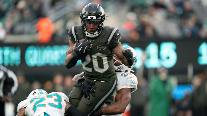 New York Jets running back Breece Hall (20) runs the ball before being tackled by Miami Dolphins linebacker Tyrel Dodson (25) during a week 14 football game between the New York Jets and Miami Dolphins at MetLife Stadium on Sunday, Dec. 7, 2025.