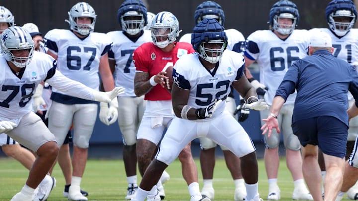 Dallas Cowboys quarterback Dak Prescott prepares to take the snap as guard Tyler Booker blocks.