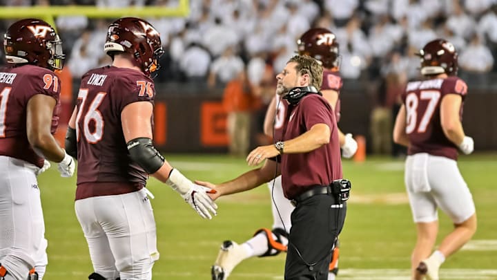 Sep 13, 2025; Blacksburg, Virginia, USA;  Virginia Tech Hokies head coach Brent Pry celebrates a score with Virginia Tech Hokies offensive lineman Aidan Lynch (76) during the fourth quarter at Lane Stadium. Mandatory Credit: Brian Bishop-Imagn Images