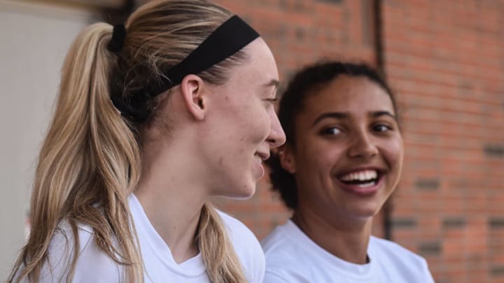 Connecticut sophomore Paige Bueckers, left, shares a laugh with freshman Azzi Fudd at a news conference on Tuesday, Oct. 19, 2021.