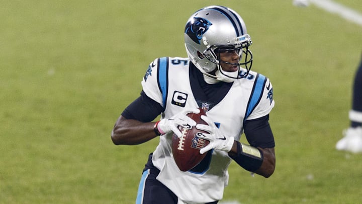 Dec 19, 2020; Green Bay, Wisconsin, USA;  Carolina Panthers quarterback Teddy Bridgewater (5) rolls out of the pocket during the first quarter against the Green Bay Packers at Lambeau Field. Mandatory Credit: Jeff Hanisch-Imagn Images