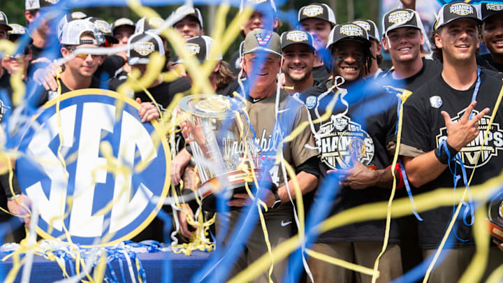Vanderbilt Commodores head coach Tim Corbin and his team celebrate with the championship trophy as Ole Miss Rebels take on Vanderbilt Commodores during the SEC baseball tournament championship game at Hoover Met in Birmingham, Ala., on Sunday, May 25, 2025. Vanderbilt Commodores defeated Ole Miss Rebels 3-2.