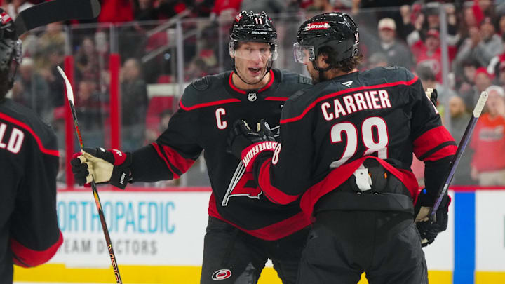 Dec 15, 2024; Raleigh, North Carolina, USA;  Carolina Hurricanes left wing William Carrier (28) celebrates a goal with center Jordan Staal (11) against the Columbus Blue Jackets during the first period at Lenovo Center. Mandatory Credit: James Guillory-Imagn Images