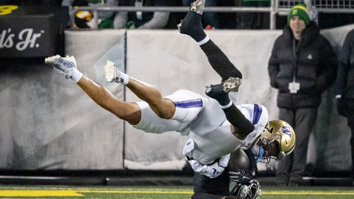 Oregon wide receiver Evan Stewart is tackled by Washington cornerback Thaddeus Dixon as the No. 1 Oregon Ducks host the Washington Huskies Saturday, Nov. 30, 2024 at Autzen Stadium in Eugene, Ore.