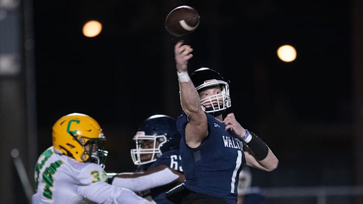 Quarterback Wells Bettenhausen (1) gets off the pass under pressure during the Catholic vs Walton high school playoff football game at Walton HIgh School in DeFuniak Springs on Friday, Nov. 17, 2023. Quarterback Wells Bettenhausen (1) gets off the pass under pressure during the Catholic vs Walton high school playoff football game at Walton HIgh School in DeFuniak Springs on Friday, Nov. 17, 2023.