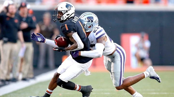 Oklahoma State's Tay Martin (1) is tackled by Kansas State's Julius Brents (23) in the second quarter during the college football game between the Oklahoma State University Cowboys (OSU) and the Kansas State University Wildcats at Boone Pickens Stadium in Stillwater, Okla., Saturday, Sept. 25, 2021. OSU won 31-20.

Osu Vs Kstate