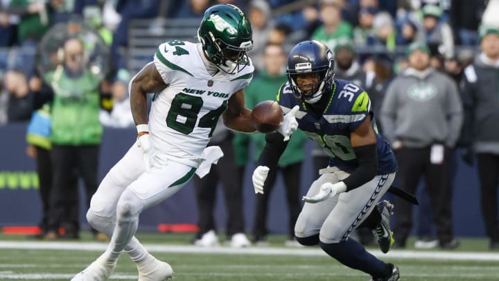 Jan 1, 2023; Seattle, Washington, USA; New York Jets wide receiver Corey Davis (84) catches a pass against Seattle Seahawks cornerback Mike Jackson (30) during the fourth quarter at Lumen Field.