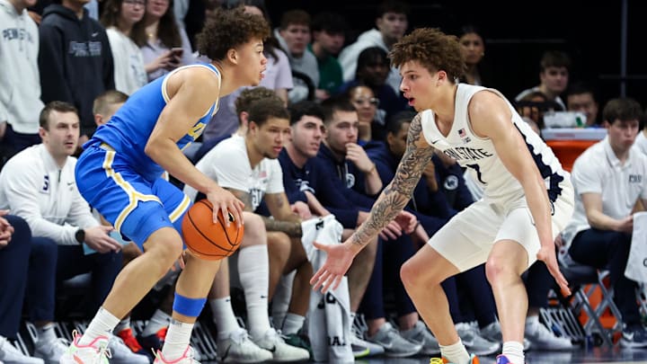 Jan 14, 2026; University Park, Pennsylvania, USA; UCLA Bruins guard Trent Perry (0) dribbles the ball as Penn State Nittany Lions guard Dominick Stewart (7) defends during the first half at Bryce Jordan Center. Mandatory Credit: Matthew O'Haren-Imagn Images