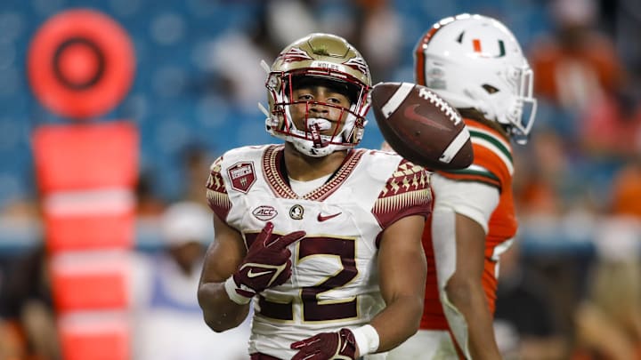 Nov 5, 2022; Miami Gardens, Florida, USA; Florida State Seminoles running back CJ Campbell (22) tosses the football after scoring a touchdown during the fourth quarter against the Miami Hurricanes at Hard Rock Stadium. Mandatory Credit: Sam Navarro-Imagn Images