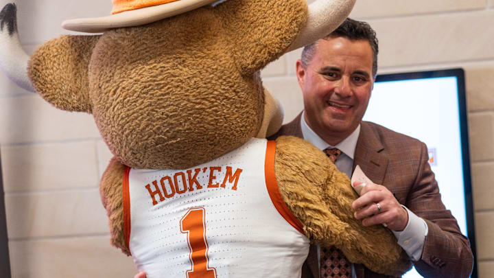 Sean Miller hugs Hook 'Em as he is announced as the University of Texas's new men's basketball coach on Tuesday, March 25, 2025.