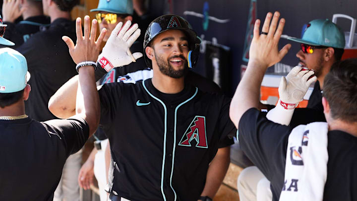 Arizona Diamondbacks Jordan Lawlar receives high-fives in the dugout after hitting a two-run home run off Milwaukee Brewers pitcher Tyler Alexander in the second inning of a spring training game at Salt River Fields at Talking Stick on Feb. 26, 2025. Arizona Diamondbacks Jordan Lawlar receives high-fives in the dugout after hitting a two-run home run off Milwaukee Brewers pitcher Tyler Alexander in the second inning of a spring training game at Salt River Fields at Talking Stick on Feb. 26, 2025.