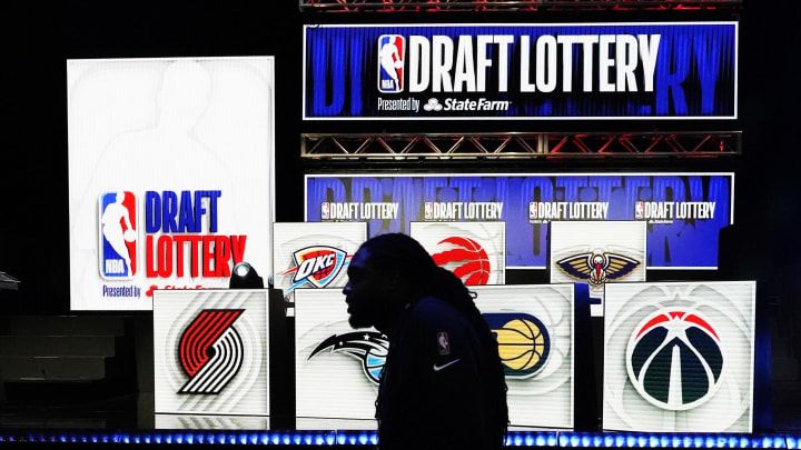 May 16, 2023; Chicago, IL, USA; People walk past the 2023 NBA Draft Lottery board at McCormick Place
