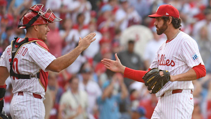 Mar 31, 2025; Philadelphia, Pennsylvania, USA; Philadelphia Phillies catcher J.T. Realmuto (10) and pitcher Jordan Romano (68) celebrate win against the Colorado Rockies at Citizens Bank Park. 