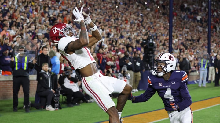 Nov 25, 2023; Auburn, Alabama, USA;  Alabama Crimson Tide wide receiver Isaiah Bond (17) scores the game winning touchdown over Auburn Tigers cornerback D.J. James (4) during the fourth quarter at Jordan-Hare Stadium. Mandatory Credit: John Reed-USA TODAY Sports