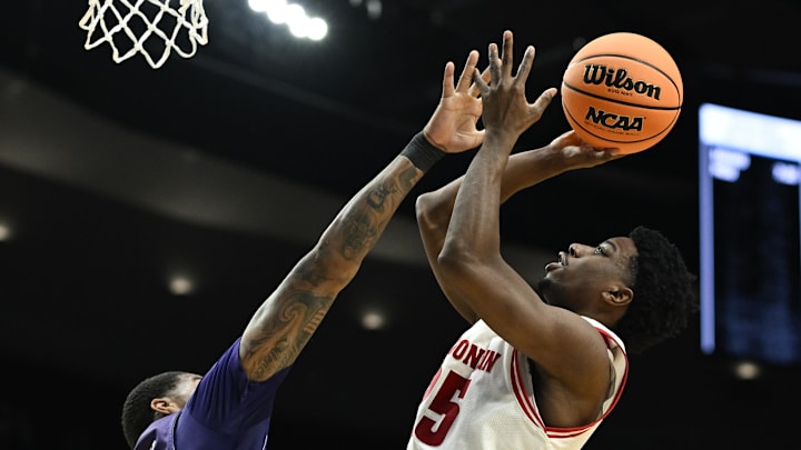 Mar 19, 2026; Portland, OR, USA; Wisconsin Badgers guard John Blackwell (25) shoots against High Point Panthers forward Cam'ron Fletcher (11) during the second half of a first round game of the men's 2026 NCAA Tournament at Moda Center. Mandatory Credit: Troy Wayrynen-Imagn Images Mar 19, 2026; Portland, OR, USA; Wisconsin Badgers guard John Blackwell (25) shoots against High Point Panthers forward Cam'ron Fletcher (11) during the second half of a first round game of the men's 2026 NCAA Tournament at Moda Center. Mandatory Credit: Troy Wayrynen-Imagn Images