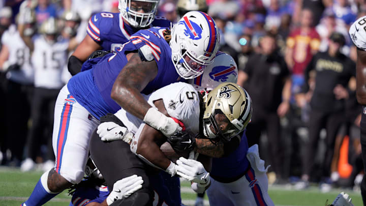 Buffalo Bills Jordan Phillips, Dorian Williams and another teammate wrap up New Orleans Saints running back Kendre Miller and stop his run during second half action of the Bills home game against the New Orleans Saints in Orchard Park on Sept. 28, 2025.