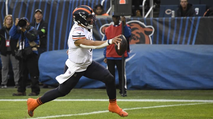 Dec 24, 2023; Chicago, Illinois, USA; Chicago Bears quarterback Justin Fields (1) scores a Dec 24, 2023; Chicago, Illinois, USA; Chicago Bears quarterback Justin Fields (1) scores a