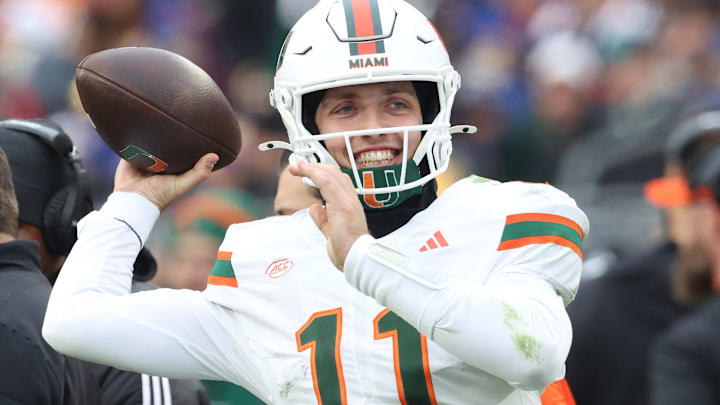 Miami Hurricanes quarterback Carson Beck (11) throws on the sidelines to keep loose during the third quarter against the Pittsburgh Panthers at Acrisure Stadium.