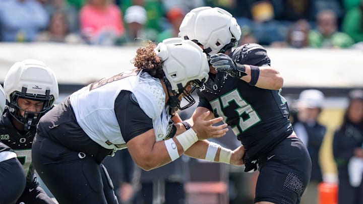 Fighting Ducks offensive lineman Lipe Moala, left, blocks Combat Ducks inside linebacker Brayden Platt as the Fighting Ducks face off against Mighty Oregon in the Oregon Ducks spring game on April 26, 2025, at Autzen Stadium in Eugene.
