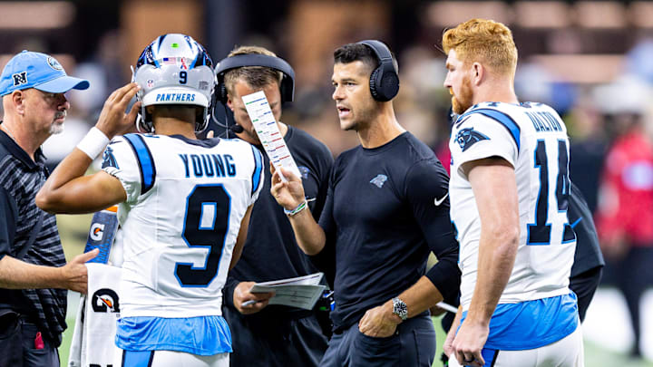 Sep 8, 2024; New Orleans, Louisiana, USA;  Carolina Panthers head coach Dave Canales talks to quarterback Bryce Young (9) and quarterback Andy Dalton (14) on a time out against the New Orleans Saints during the first half at Caesars Superdome. Mandatory Credit: Stephen Lew-Imagn Images