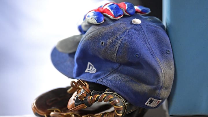 Sep 14, 2021; Los Angeles, California, USA;  The glove, hat and batting glove of Los Angeles Dodgers third baseman Justin Turner (10) are seen in the dugout during a game against the Arizona Diamondbacks at Dodger Stadium. Mandatory Credit: Jayne Kamin-Oncea-Imagn Images