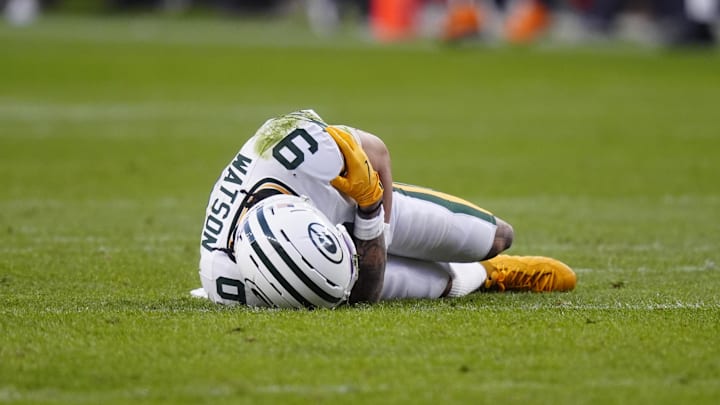 Dec 14, 2025; Denver, Colorado, USA; Green Bay Packers wide receiver Christian Watson (9) lies on the field following an injury during the third quarter against the Denver Broncos at Empower Field at Mile High. Mandatory Credit: Ron Chenoy-Imagn Images