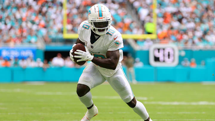 Nov 17, 2024; Miami Gardens, Florida, USA; Miami Dolphins wide receiver Tyreek Hill (10) runs with the football against the Las Vegas Raiders during the first quarter at Hard Rock Stadium. Mandatory Credit: Sam Navarro-Imagn Images