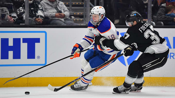 Edmonton Oilers left wing Zach Hyman (18) moves the puck against Los Angeles Kings left wing Warren Foegele (37)