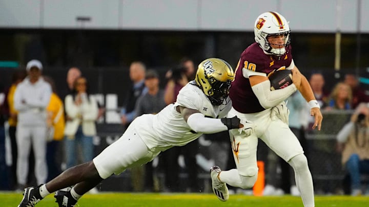 UCF defensive end Malachi Lawrence (51) tackles ASU quarterback Sam Leavitt (10) as he scrambles during a game at Mountain America Stadium in Tempe on Nov. 9, 2024.