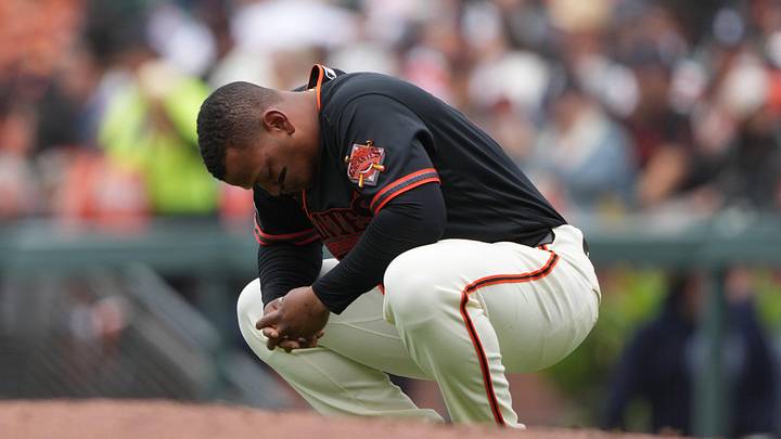 Apr 25, 2026; San Francisco, California, USA; San Francisco Giants first baseman Rafael Devers (16) kneels near first base after striking out against the Miami Marlins during the first inning at Oracle Park. Mandatory Credit: Darren Yamashita-Imagn Images