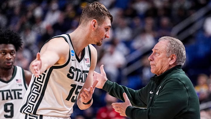 Michigan State center Carson Cooper (15) talks to head coach Tom Izzo after a play against Louisville during the second half of NCAA Tournament Second Round at KeyBank Center in Buffalo on Saturday, March 21, 2026.
