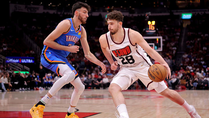 Apr 4, 2025; Houston, Texas, USA; Houston Rockets center Alperen Sengun (28) handles the ball against Oklahoma City Thunder forward Chet Holmgren (7) during the first quarter at Toyota Center. Mandatory Credit: Erik Williams-Imagn Images