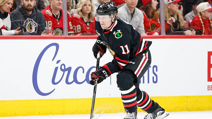 Jan 23, 2026; Chicago, Illinois, USA; Chicago Blackhawks center Oliver Moore (11) controls the puck against the Tampa Bay Lightning during the first period at United Center. Mandatory Credit: Kamil Krzaczynski-Imagn Images