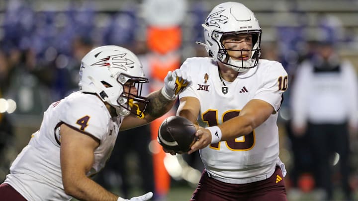 Nov 16, 2024; Manhattan, Kansas, USA; Arizona State Sun Devils quarterback Sam Leavitt (10) hands off to running back Cam Skattebo (4) against the Kansas State Wildcats during the second quarter at Bill Snyder Family Football Stadium. Mandatory Credit: Scott Sewell-Imagn Images
