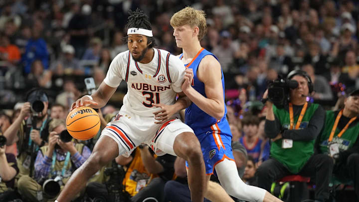 Apr 5, 2025; San Antonio, TX, USA;  Auburn Tigers forward Chaney Johnson (31) dribbles against Florida Gators forward Thomas Haugh (10) in the semifinals of the men's Final Four of the 2025 NCAA Tournament at the Alamodome. Mandatory Credit: Robert Deutsch-Imagn Images