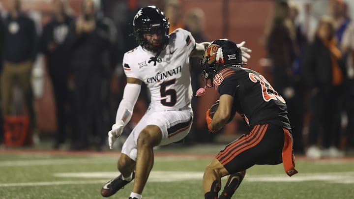 Nov 1, 2025; Salt Lake City, Utah, USA; Cincinnati Bearcats safety Christian Harrison (5) tackles Utah Utes wide receiver Mana Carvalho (28) on a punt return during the first quarter at Rice-Eccles Stadium. Mandatory Credit: Rob Gray-Imagn Images Nov 1, 2025; Salt Lake City, Utah, USA; Cincinnati Bearcats safety Christian Harrison (5) tackles Utah Utes wide receiver Mana Carvalho (28) on a punt return during the first quarter at Rice-Eccles Stadium. Mandatory Credit: Rob Gray-Imagn Images