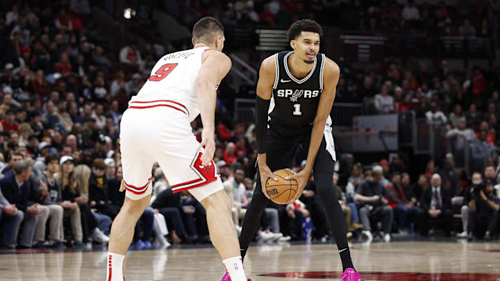 Jan 6, 2025; Chicago, Illinois, USA; San Antonio Spurs center Victor Wembanyama (1) looks to pass the ball against Chicago Bulls center Nikola Vucevic (9) during the first half at United Center. Mandatory Credit: Kamil Krzaczynski-Imagn Images