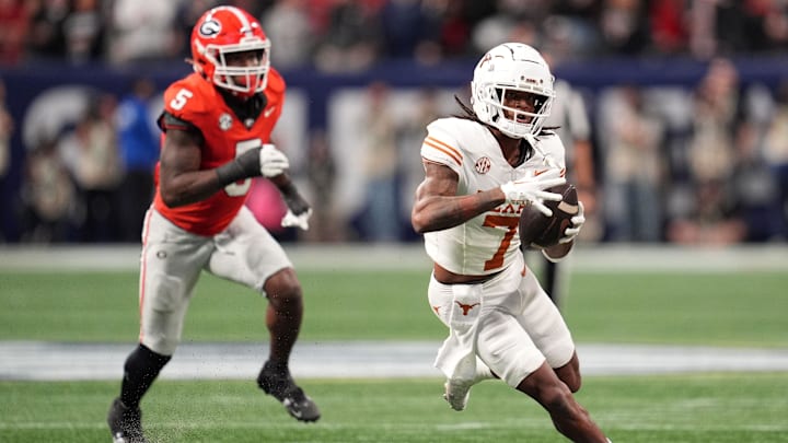 Dec 7, 2024; Atlanta, GA, USA; Texas Longhorns wide receiver Isaiah Bond (7) makes a catch past Georgia Bulldogs linebacker Raylen Wilson (5) during the first half in the 2024 SEC Championship game at Mercedes-Benz Stadium. Mandatory Credit: Dale Zanine-Imagn Images