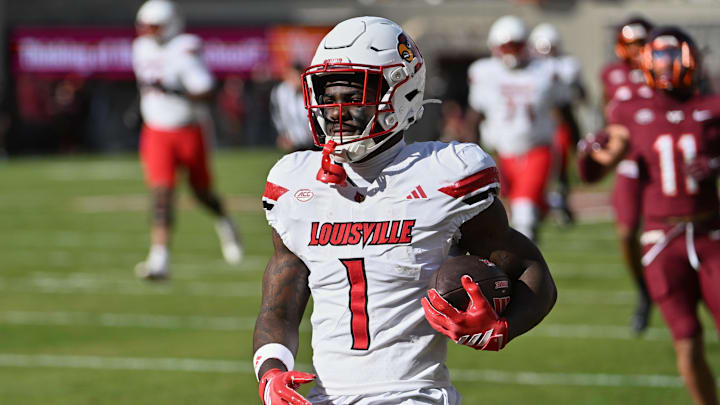 Nov 1, 2025; Blacksburg, Virginia, USA;  Louisville Cardinals running back Isaac Brown (1) reacts after scoring a touchdown against the Virginia Tech Hokies during the first quarter at Lane Stadium. Mandatory Credit: Brian Bishop-Imagn Images